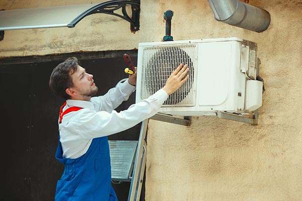 hvac-technician-working-capacitor-part-condensing-unit-male-worker-repairman-uniform-repairing-adjusting-conditioning-system-diagnosing-looking-technical-issues